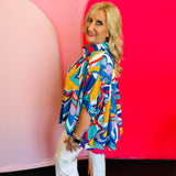 Side profile of the Blue Printed Blouse featuring the short dolman sleeves and flowy structure, showing movement and comfort in the design.