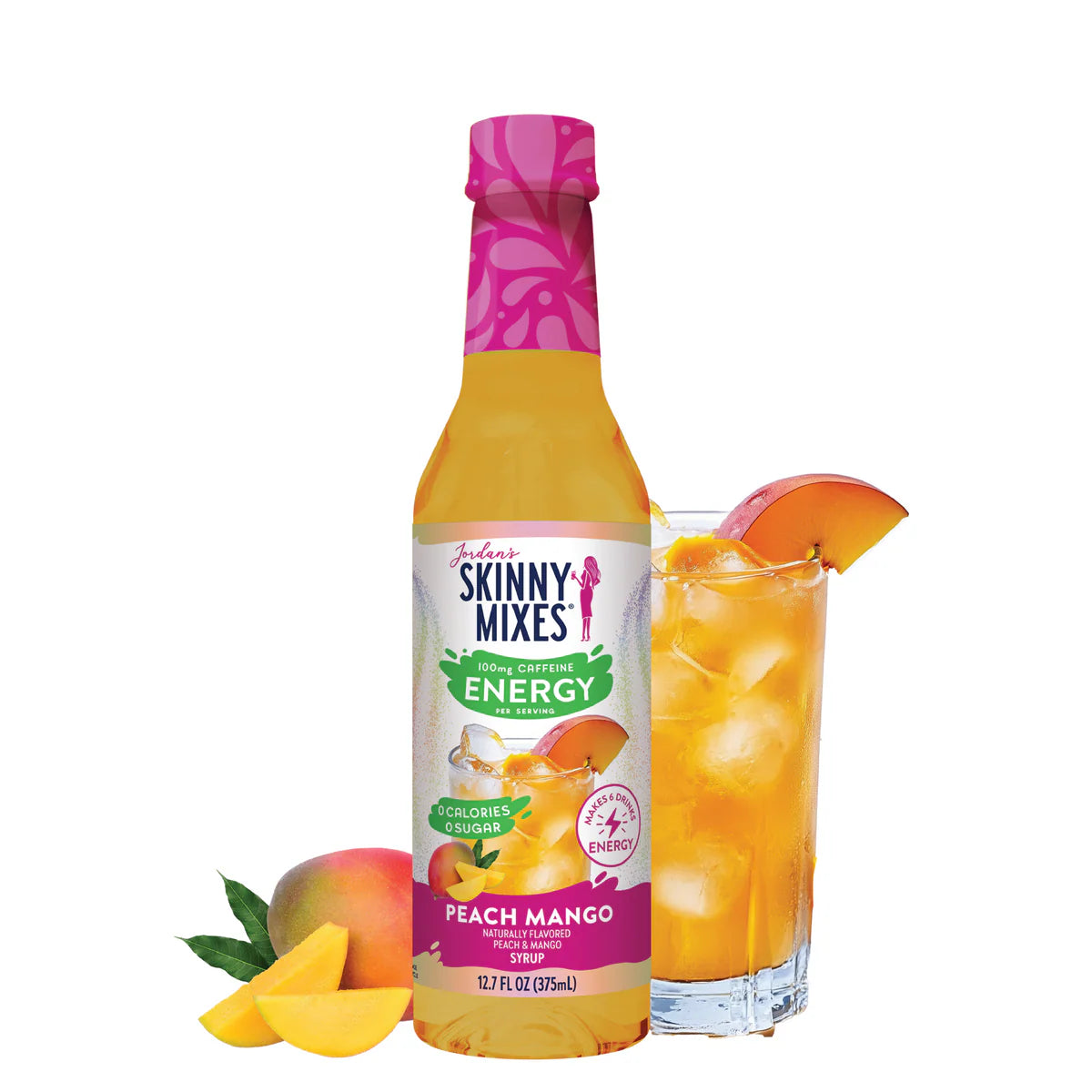 A bottle of Skinny Mixes SF Peach Mango Energy Syrup is positioned next to a tall, refreshing glass of a golden-orange energy drink, garnished with fresh peach and mango slices.