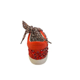 Back view of the GOLDIE sneakers showing the heel height, red rhinestones, and leopard shoelaces.