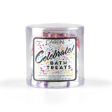 Three cheerful, round bath bombs in light, festive colors with colorful speckles.