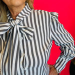 Close up of Charcoal black striped front bow tie blouse.