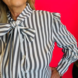 Close up of Charcoal black striped front bow tie blouse.