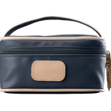 A charcoal colored Jon Hart mini makeup case with natural leather trim and a leather patch for personalization.