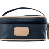 A navy colored Jon Hart mini makeup case with natural leather trim and a leather patch for personalization.