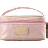A rose colored Jon Hart mini makeup case with natural leather trim and a leather patch for personalization.