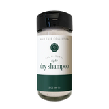 A bottle of Rowe Casa dry shampoo, 2 oz size