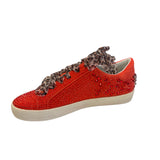 Inner side of red embellished sneaker with clean vegan leather finish and rhinestone embellishments.
