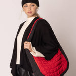red bag with black sides quilted puffer bag