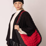 red bag with black sides quilted puffer bag