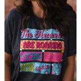 Heather graphite tee with pink, yellow, and turquoise graphics, "The Heavens Are Roaring The Promise Of Your Glory You Are Raised To Life Again."