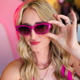 Close-up of the Sawtelle Berry Gradient Sunglasses highlighting the fuchsia-to-black gradient lenses, sharp cat eye edges, and sleek metal detailing.