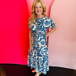 Cobalt blue and white floral print tiered maxi dress with short sleeves and a belted waist.