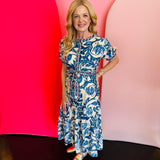 Cobalt blue and white floral print tiered maxi dress with short sleeves and a belted waist.