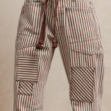 Mocha striped barrel jeans with patches and corded belt.