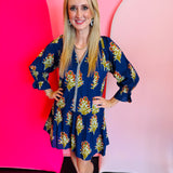 Blue floral dress with navy and white striped front trim and ruffle hemline