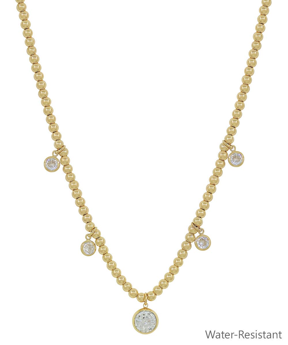 Gold beaded necklace with graduated crystal circle charms, water-resistant, adjustable 16"-18".