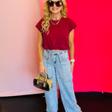 Full-body view of the Blakeley Jovie Tie Waist Jeans styled with a maroon top and sandals, showcasing the relaxed, boho-inspired summer look.