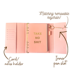 Inside view of pink magnetic closure journal folio and calendar with gold graphics.
