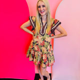 Brown floral print mini dress with flutter sleeves and tiered hem.