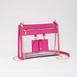 Fuchsia clear crossbody bag with gold hardware and removable sunglasses holder, combining bold style with stadium-friendly function.