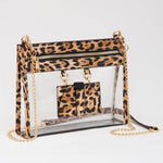 Leopard-trimmed clear crossbody bag with gold hardware and built-in sunglasses holder—stylish, functional, and stadium-ready.