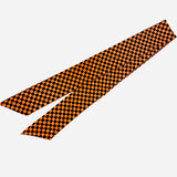 Orange and black checkered scarf tie styled as a chic twilly or scarf necklace.