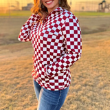 Maroon and white checkered pullover with a collared neckline, quarter-zip front, and kangaroo pocket, laid flat to showcase the bold pattern and design.