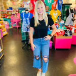 Blackberry colored washed cropped jeans with distressed knees and raw hem