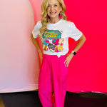 Full outfit view featuring the Vaya Con Dios Tee styled with bright pink pants for a cheerful and vibrant look.