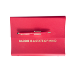 Red clutch organizer with a pen and 'Baddie is a State of Mind' text.