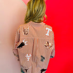 Back of Queen Of Sparkles orange and white striped icon University Of Texas game day blouse.