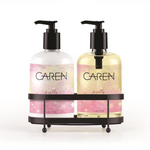 A 14 oz bottle of "Pretty" hand wash and a 14 oz bottle of hand treatment sitting in a black sink-side caddy.