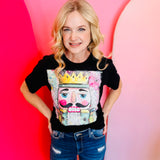 Black tee with colorful nutcracker king graphic in a square design.