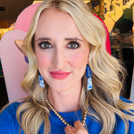 Model wearing the Blue White Floral Dangle Earrings, showcasing their playful link shape and crisp blue and white floral design against a casual outfit.