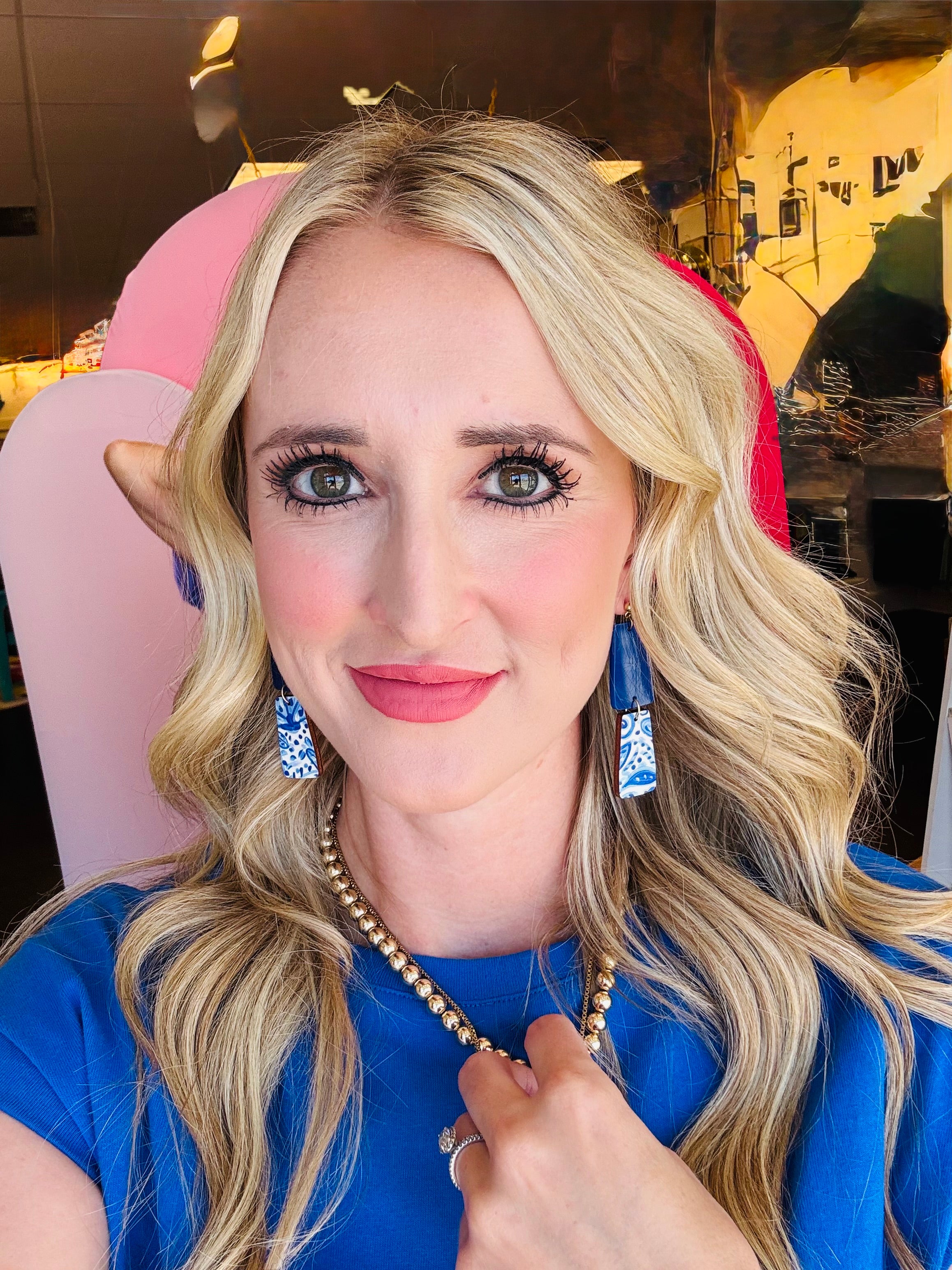 Model wearing the Blue White Floral Dangle Earrings, showcasing their playful link shape and crisp blue and white floral design against a casual outfit.