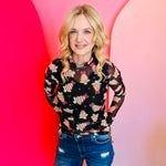Sheer mesh top with neon holiday tree print, pink stars, mock neck, and lettuce hems.