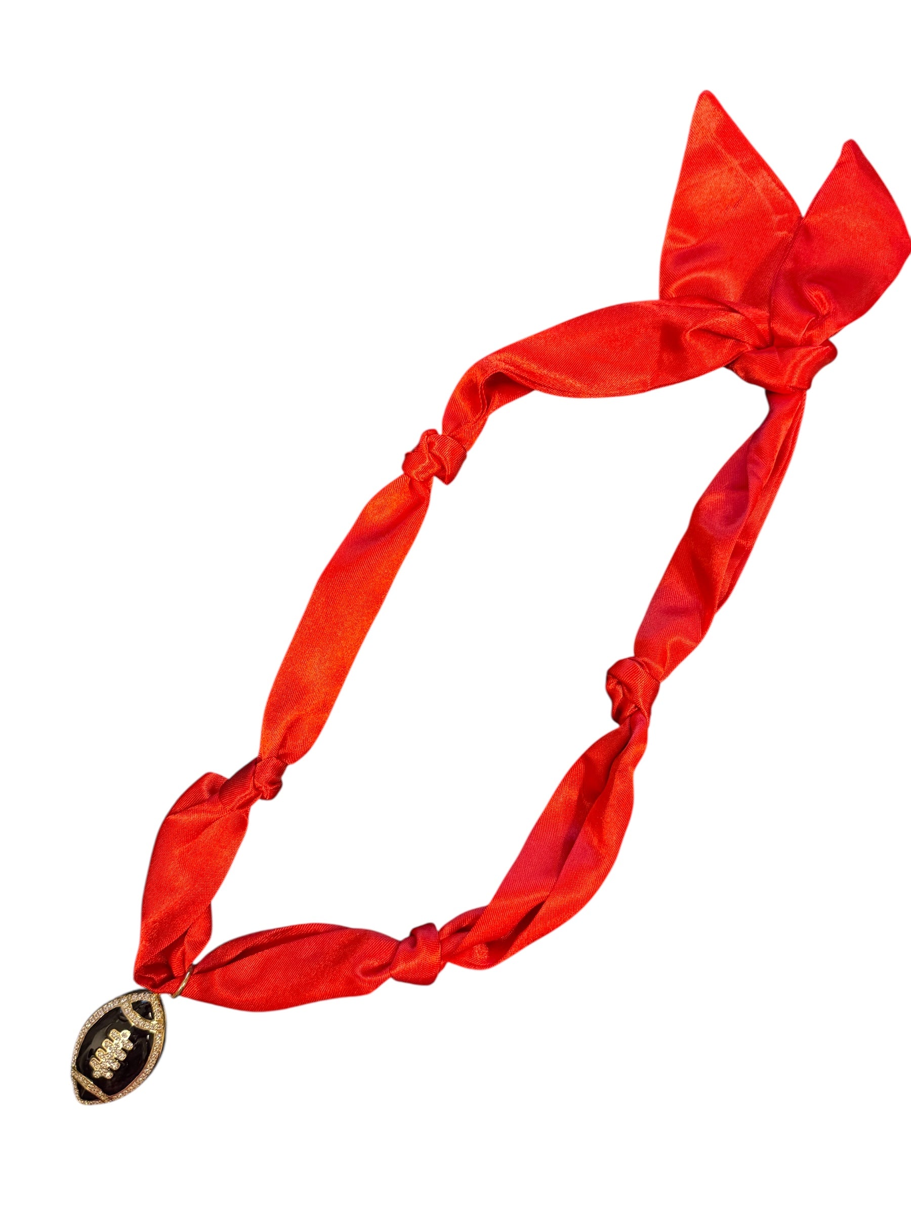 Red satin scarf necklace with a black rhinestone encrusted football charm.