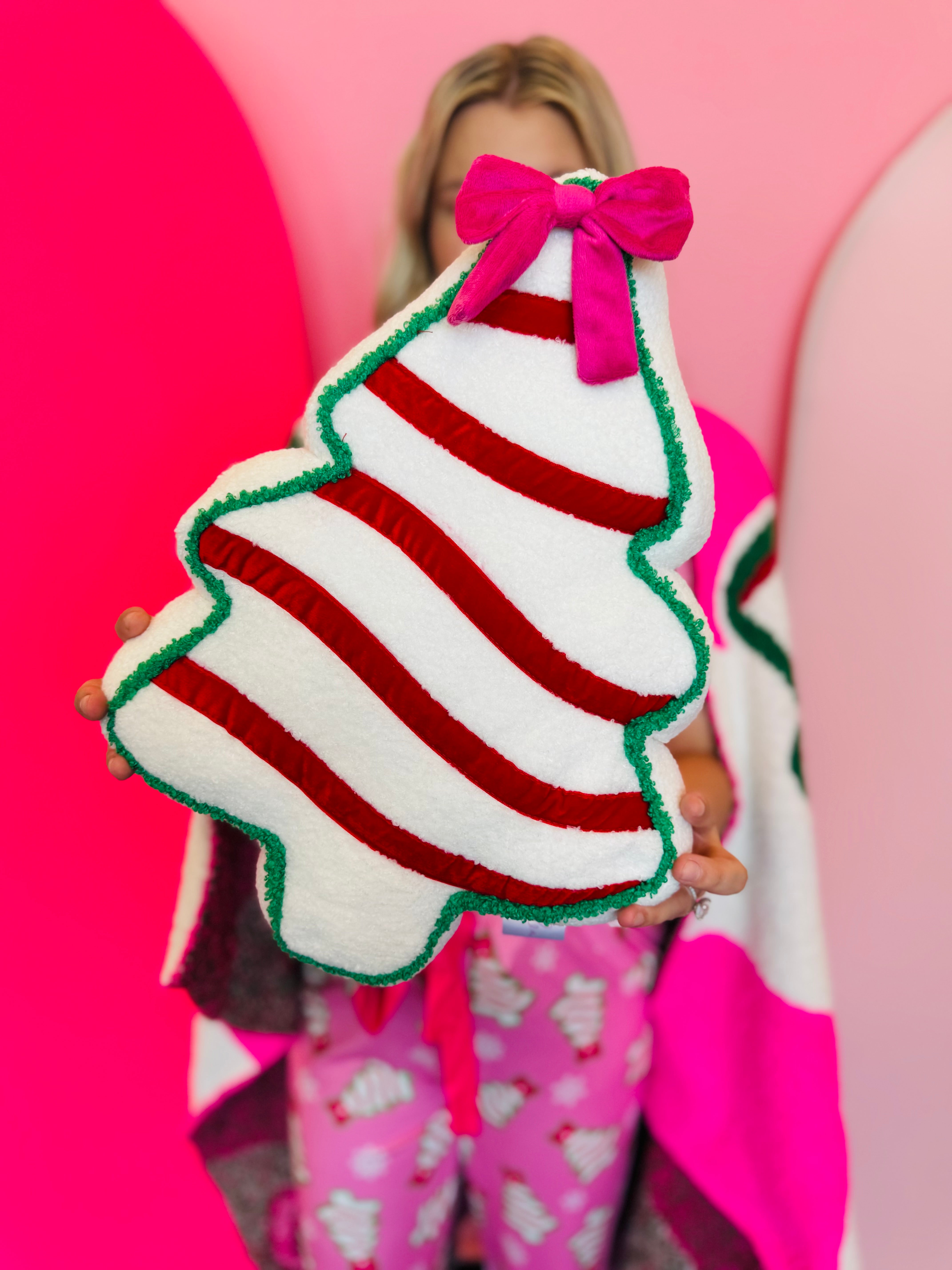 Pink bow Christmas treat pillow for festive home decor.