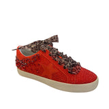 Side profile of red vegan leather sneaker featuring a bold rhinestone star embellishment and slight platform heel with leopard laces.