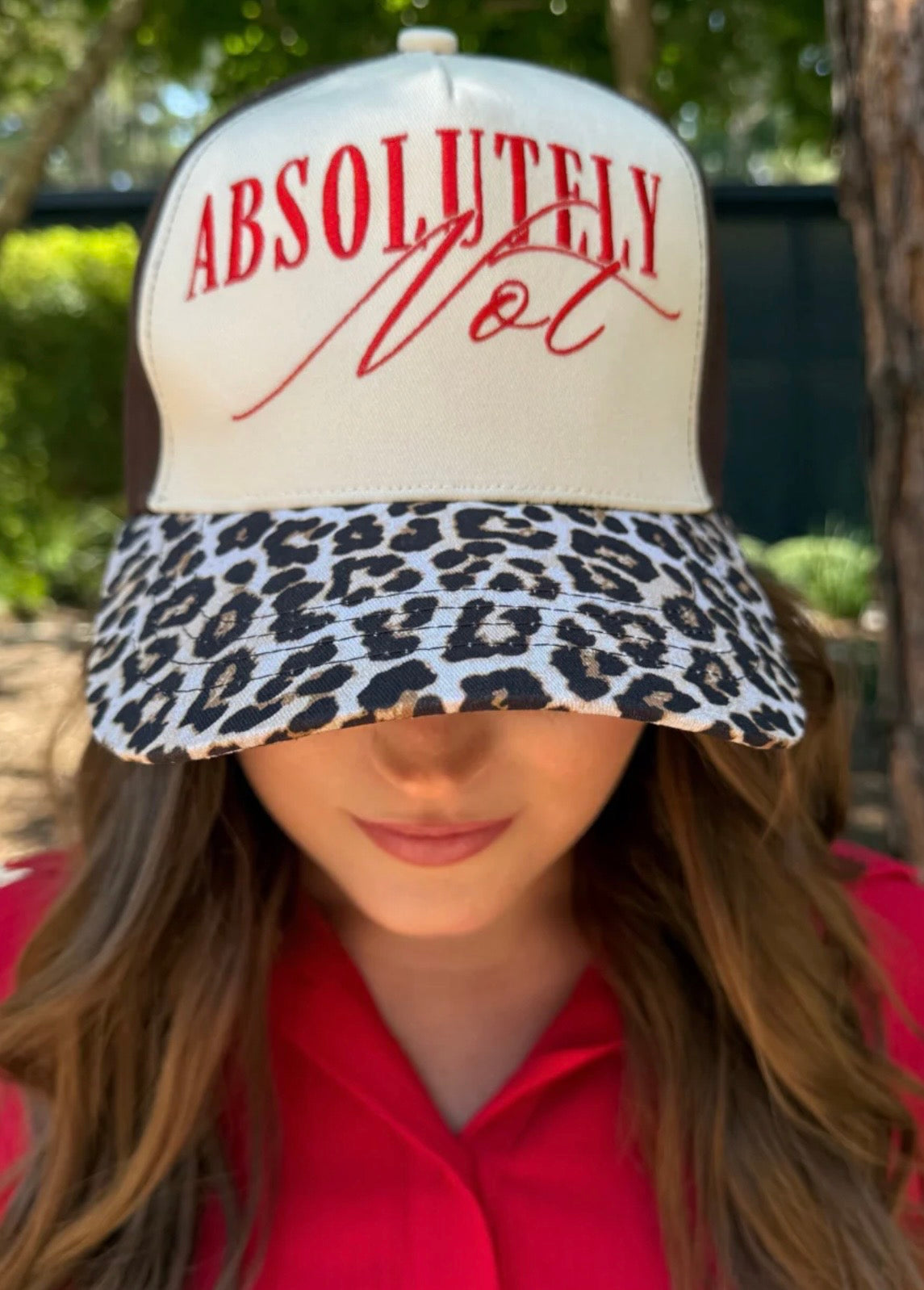 Cream and leopard print hat with red embroidered “Absolutely Not” lettering.