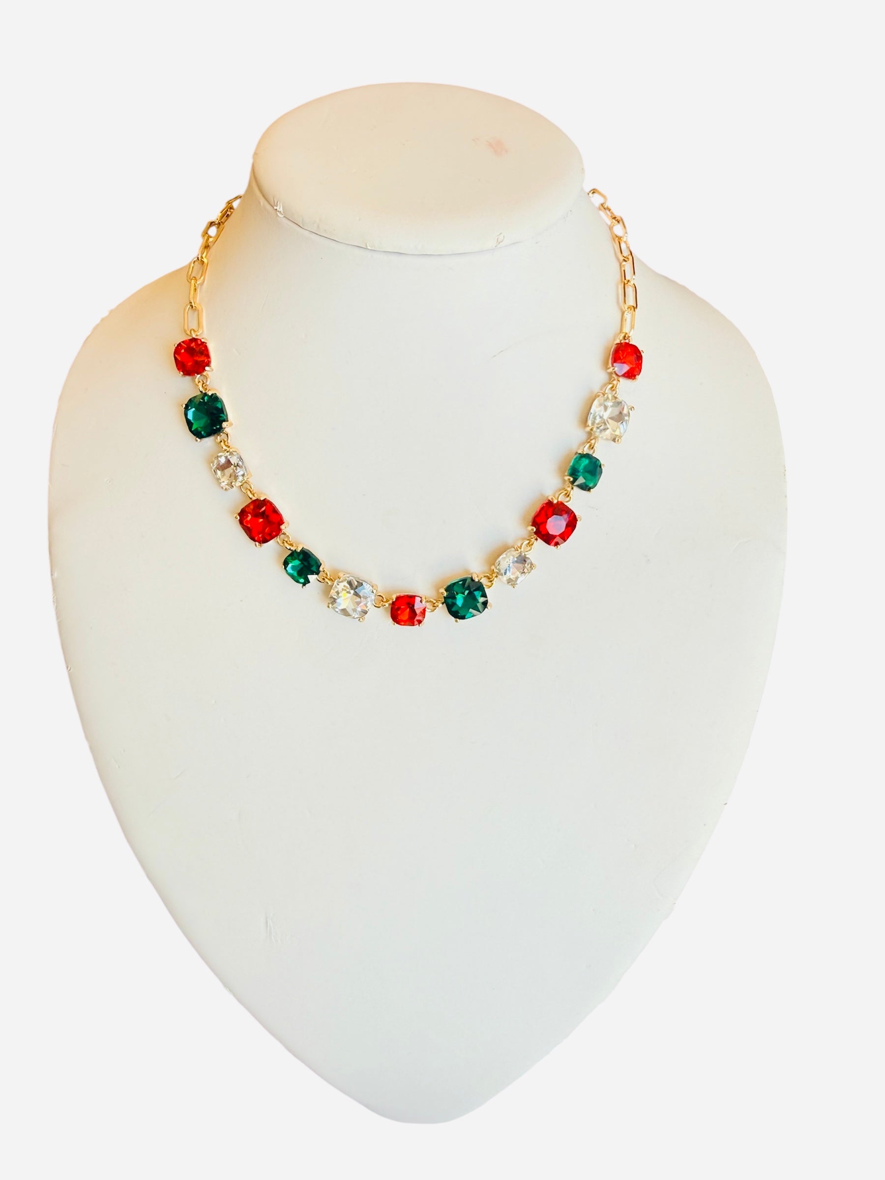 Gold-tone necklace with red, green, and clear faceted crystals for festive sparkle and elegance.