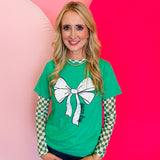 Green tee with large white bow graphic and black “Game Day” lettering on the front.