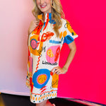 Side profile of the Sicily Calls Dress emphasizing the flattering shift shape, side seam flow, and colorful Mediterranean-inspired print for a sun-ready statement.