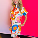 Side profile of the Sicily Calls Dress emphasizing the flattering shift shape, side seam flow, and colorful Mediterranean-inspired print for a sun-ready statement.