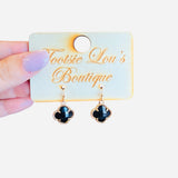 Glossy black clover dangle earrings with gold trim, lightweight and shiny for everyday or elegant wear