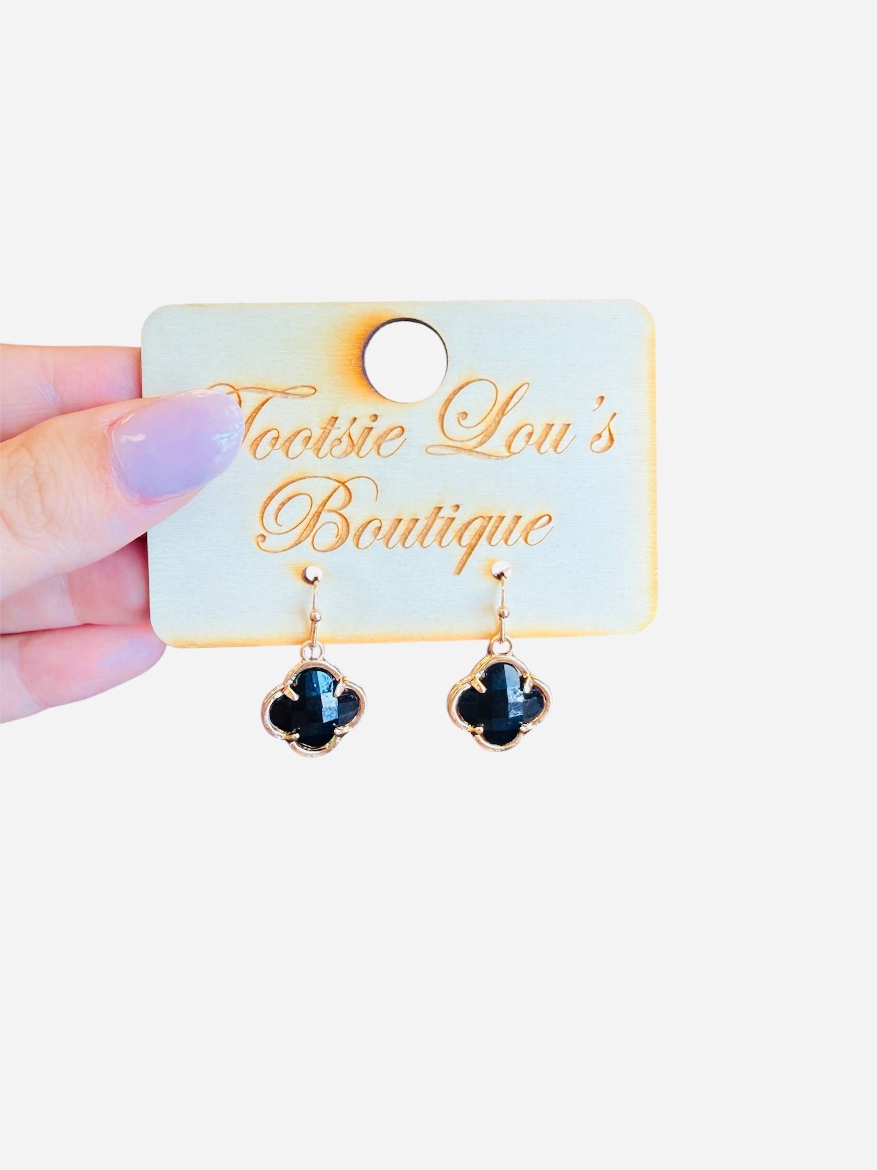 Glossy black clover dangle earrings with gold trim, lightweight and shiny for everyday or elegant wear