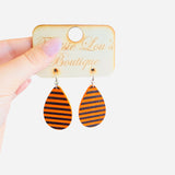 Teardrop earrings with black and orange horizontal stripes.