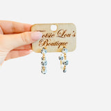 Water-resistant Chinoiserie hoop earrings with black, white, and gold beads.