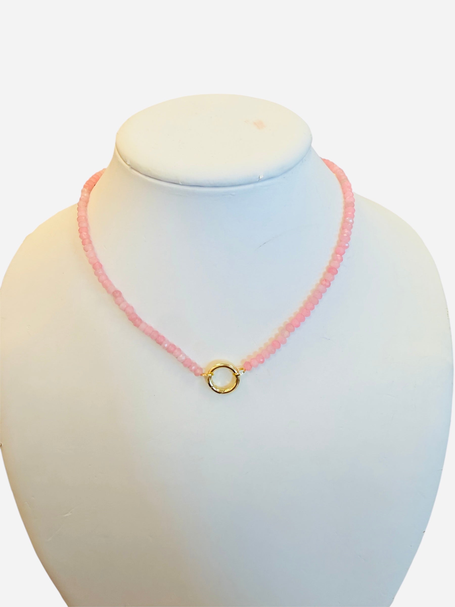 Blush Glow Necklace with faceted pink beads, gold central bead with charm clip, and magnetic clasp.