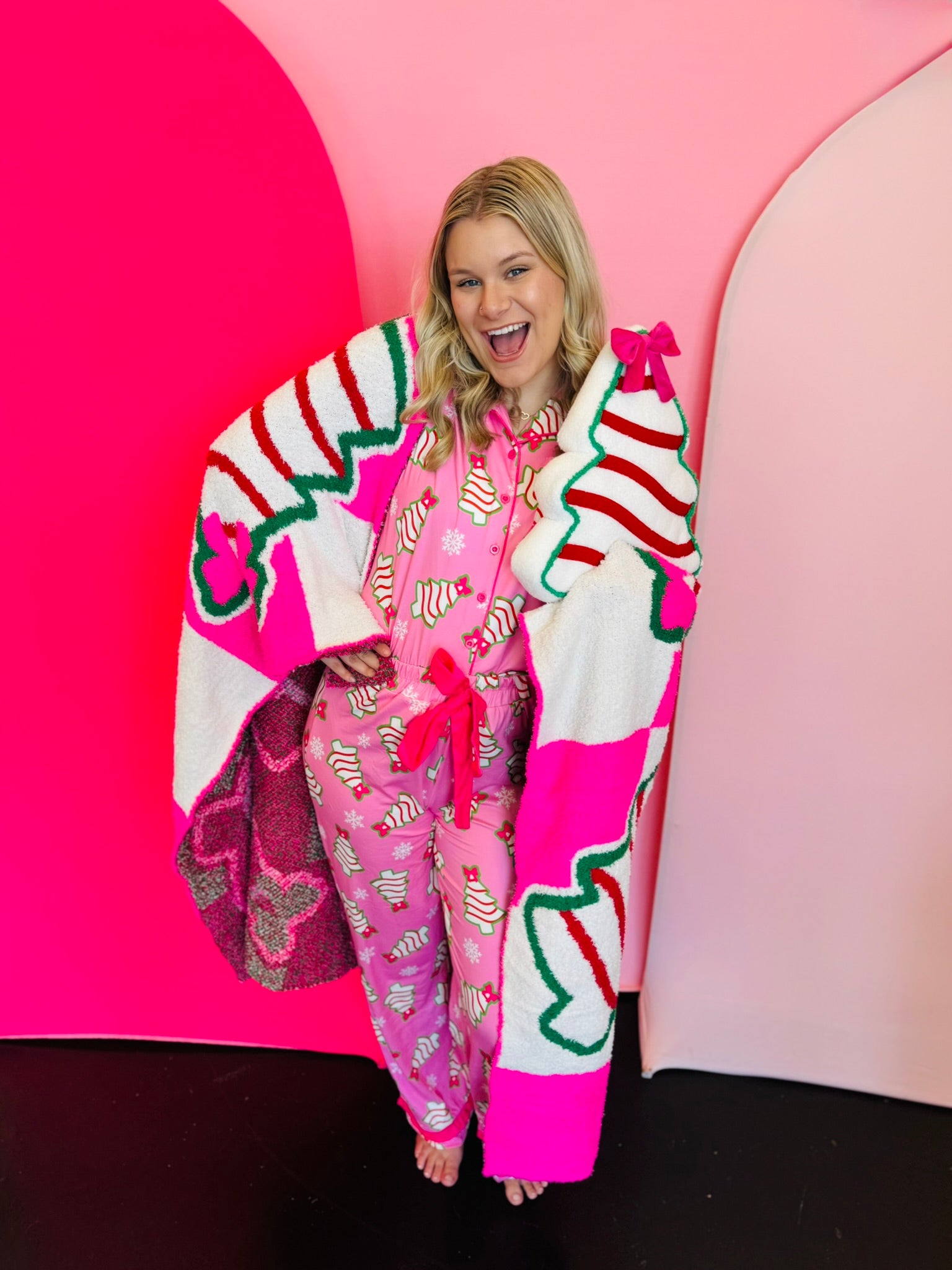 Pink Christmas pajama set with holiday treat print, ruffle trim, and drawstring pants.